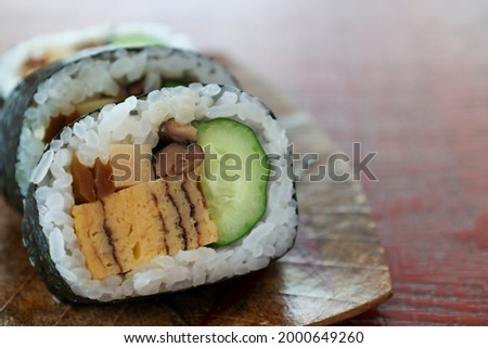 sushi rolls on a wooden plate