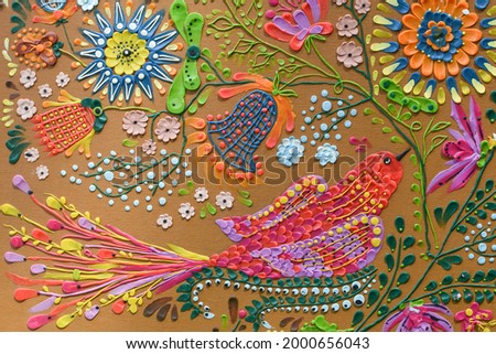 The image of a bird and flowers from plasticine