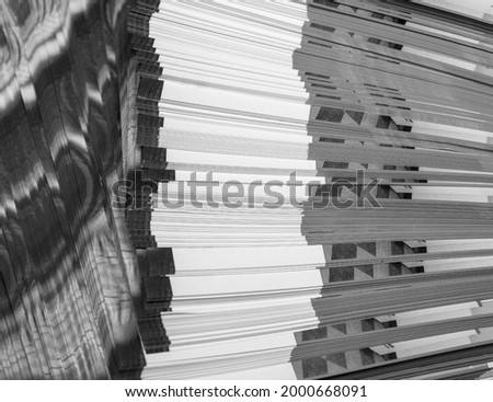Close up of black and white edges, flyers, brochures stacked with different patterns
