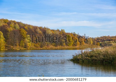 beautiful big lake in the forest in autumn 