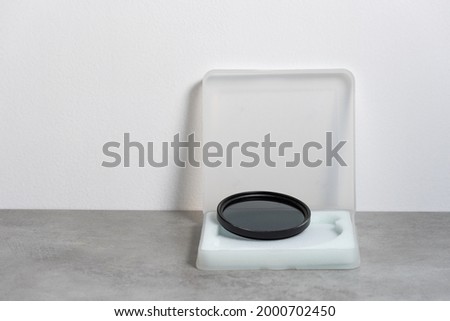 ND filter for photographic lens and its box for transport and storage