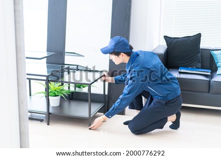 Moving company in beautiful room Royalty-Free Stock Photo #2000776292