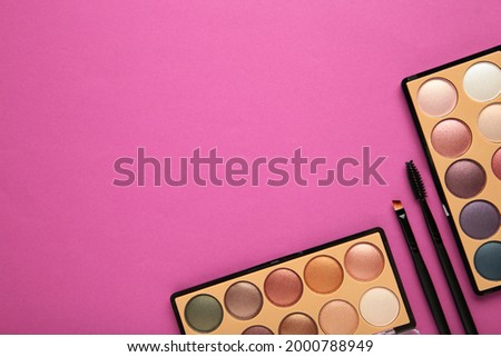 Decorative cosmetics on pink background. Makeup. Vertical photo. Top view