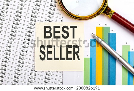 Business concept. Top view of stiscker with text BEST SELLER on the chart background