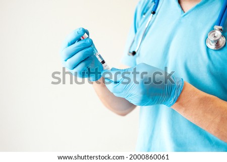 Fight against virus covid-19 corona virus, doctor, scientist or nurse, in laboratory holding a syringe with lvaccines for children or older adults on white background close up with copy space