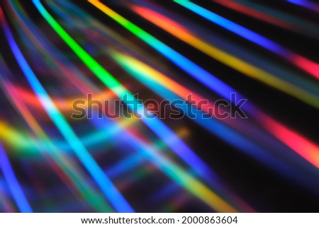 Holographic neon background. Neon rainbow strips on dark background. Soft focus Abstract rainbow color wave strips horizontal background.
