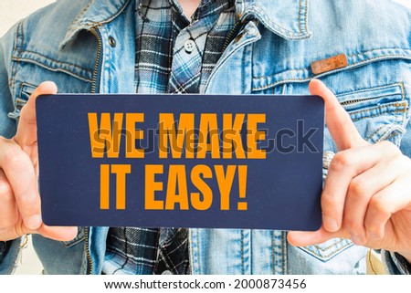 WE MAKE IT EASY! message on the card shown by a man