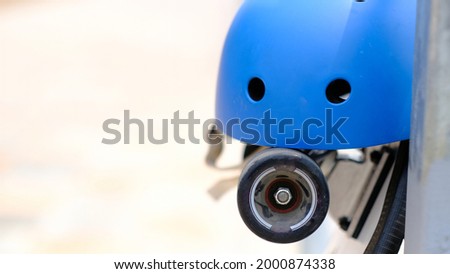 helmet placed on skateboard and has space to put text on the side.