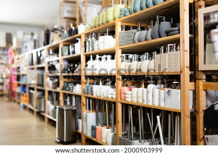Variety of bathroom accessories displayed on shelving in household goods store. Concept of organizing comfortable home space Royalty-Free Stock Photo #2000903999