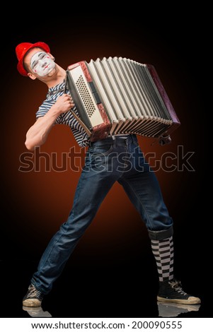 Clown playing on accordion 