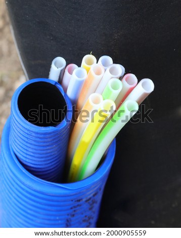 corrugated tube containing small colored tubes for the laying of optical fiber to allow connection to high-speed internet Royalty-Free Stock Photo #2000905559