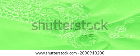 Spring green silk with lace capes. Smooth elegant green silk or luxe satin can be used as an abstract background. Background texture, postcard template