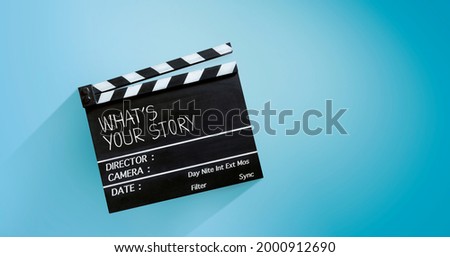 what's your story, film slate, or clapperboard on blue background.
