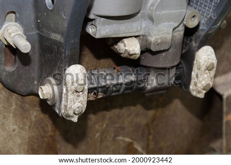 Oxidized anodes on the outboard motor clamp on the transom of a motor boat, protection of engine lower unit from corrosion in salt water Royalty-Free Stock Photo #2000923442