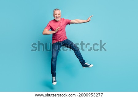 Full length body size photo smiling man jumping fighting like ninja isolated pastel blue color background