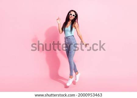 Full length body size photo woman in singlet jumping up wearing sunglass isolated pastel pink color background