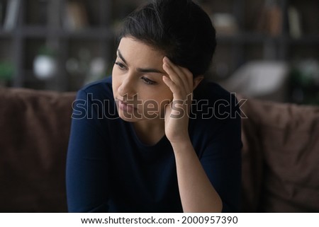 Psychological problem. Tired sad millennial female of indian ethnicity think on difficult problem going through divorce job loss. Thoughtful teen female suffer alone worry making hard choice decision Royalty-Free Stock Photo #2000957390