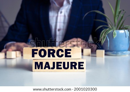 The text Force Majeure on a wooden blocks. Business concept photo