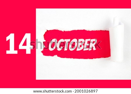 October 14th. Day 14 of month, Calendar date. Red Hole in the white paper with torn sides with calendar date. Autumn month, day of the year concept