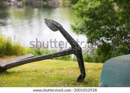 Old anchor on a lawn.