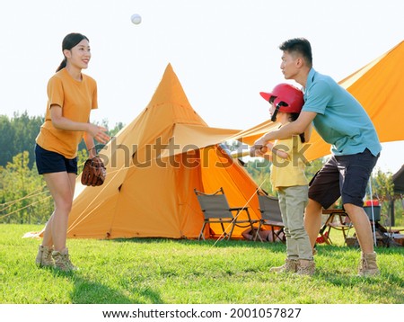 Happy family of three playing baseball in the park high quality photo