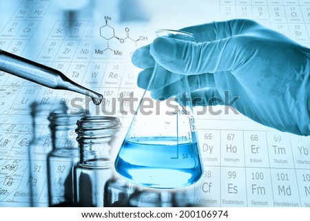 Flask in scientist hand with dropping liquid to test tube Royalty-Free Stock Photo #200106974