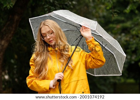 woman with umbrella on green background close-up