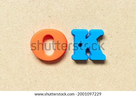 Plastic alphabet letter in word OK on wood background