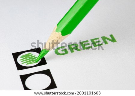 Green wooden colored pencil with colored box at go green