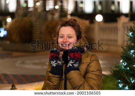A portrait of a beautiful girl in winter with many little warm lights