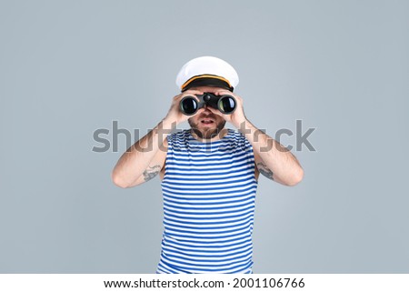 Sailor with binoculars on light grey background