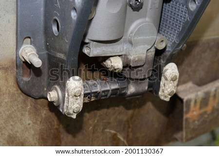 Oxidized anodes on the outboard motor clamp on the transom of a motor boat, lower uni trim and tilt cylinder protection from corrosion in salt water Royalty-Free Stock Photo #2001130367