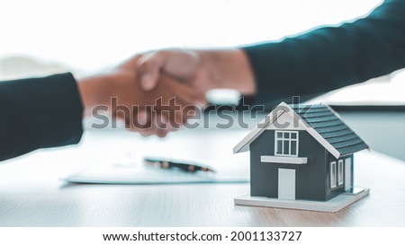 Business success, Real estate agents and customers shake hands to congratulate after signing a contract to buy a house with land and insurance, handshake and Good response concept. Royalty-Free Stock Photo #2001133727