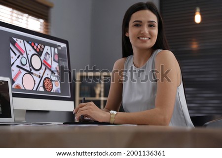 Professional retoucher working on computer in office