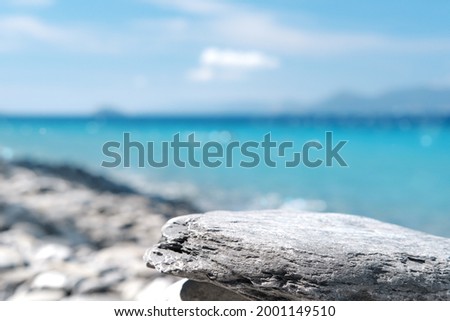 Stone rocky pedestal or podium in front of sea ocean background. Empty product template. Summer vibe. Mock-up. Stage for advertising Royalty-Free Stock Photo #2001149510
