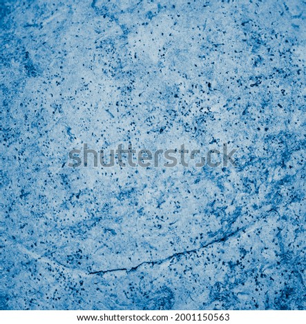old wall painted with blue paint with visible texture