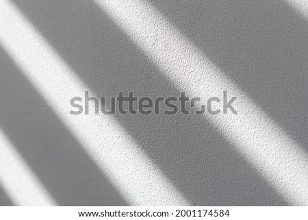 Striped shadow on white wall. Abstract geometric background. Royalty-Free Stock Photo #2001174584