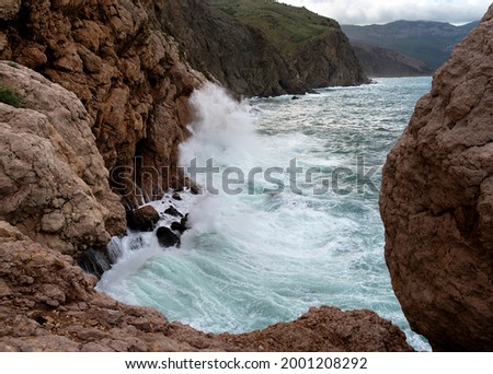 Beautiful seascape with turquoise storming water and high cliffs. Great design for any purposes. Beautiful summer landscape. Natural background. Copy space.