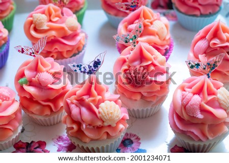 macro shot of colorful cupcake bakery soaps with pink orange icing with small shells and transparent resin mermaid tail made for home industry