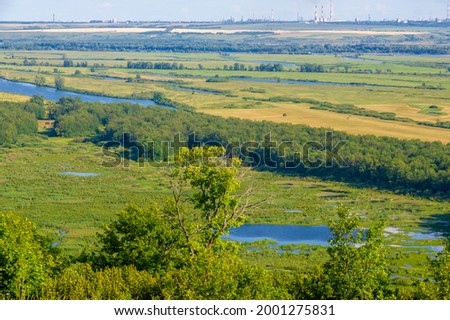 Summer landscape, river a large natural stream of water flowing in a channel to the sea, a lake, or another such stream. flood, nulla, effluent, ford. High hilly shores