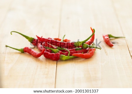 Red hot chili peppers on wooden background. Spicy chilli peppers.