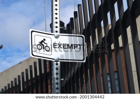 White and black bike exempt street sign                              