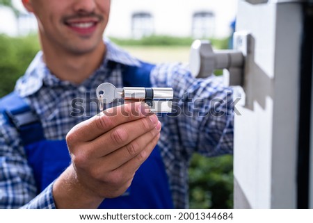 Locksmith Lock Door Repair. Worker Changing And Cylinder Royalty-Free Stock Photo #2001344684