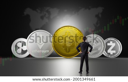 Businessman watch growing  cryptocurrencies set by bite coin leader of digital currency of symbol coins for investment property asset. Bitcoin, Ethereum, Litecoin, zcash, ripple,monero for investment. Royalty-Free Stock Photo #2001349661