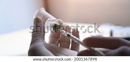 Doctor holding syringe with  vaccine in hands.