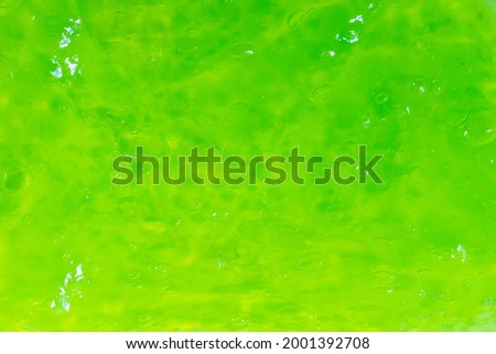 Abstract bright green background made of transparent slime with air bubbles. Royalty-Free Stock Photo #2001392708