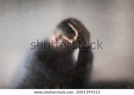 Depression. Broken man behind a dusty scratched glass. Royalty-Free Stock Photo #2001394313