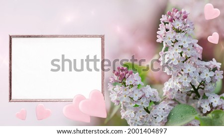 Unfocused pink background with blooming lilac, empty paper in a frame and hearts. Art design