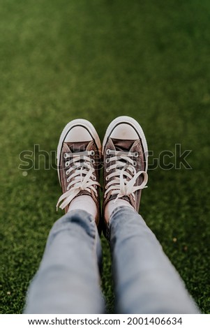 the woman who has her shoes photographed on the grass