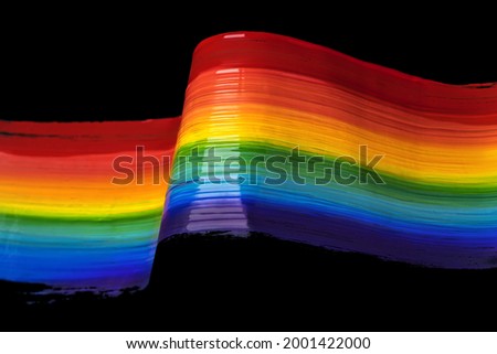 Painted Rainbow LGBT Pride flag isolated on black background. Six colored striped flag: red, orange, yellow, green, blue, and violet. 
